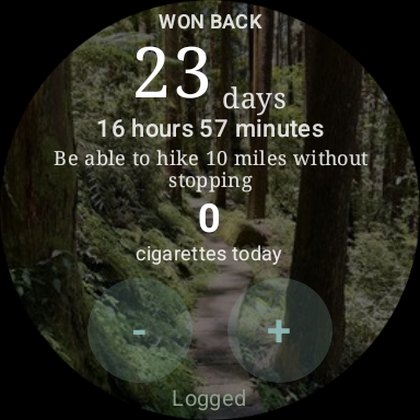 The Wear OS app on a round face: 23 days won back, today's count of zero cigarettes, and plus and minus controls for logging from the wrist.